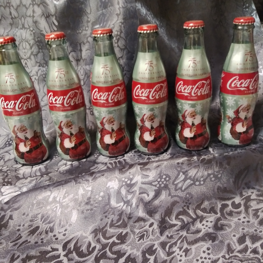 8 oz. Coca Cola Collectable bottles.